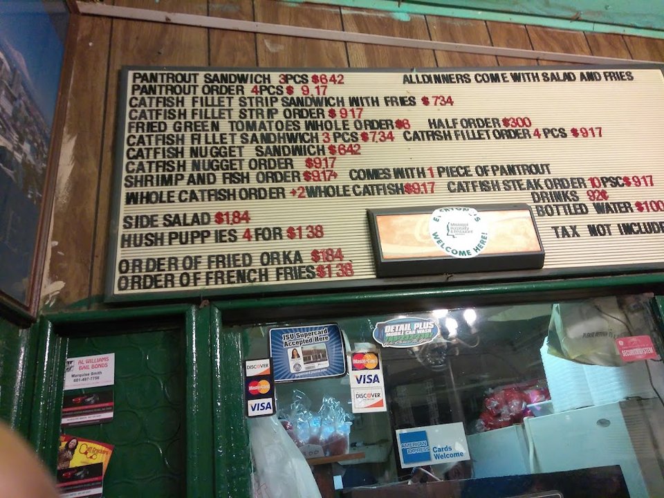 Menu board with catfish, trout, and sides.