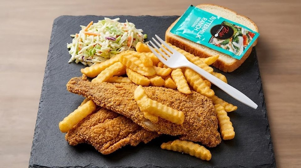 Menu board with catfish, trout, and sides.